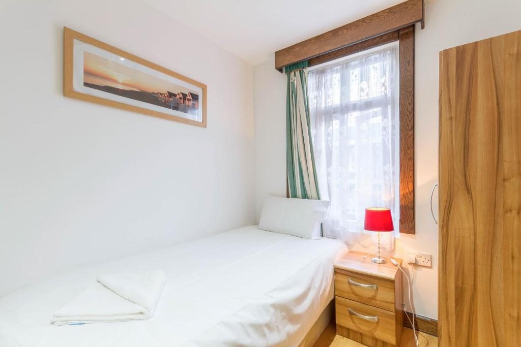 Single room with a single bed by the window